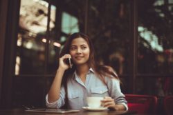lifestyle redesign  - Talking on the phone 250x167 - How to Effortlessly Find Your Tribe Starting Today